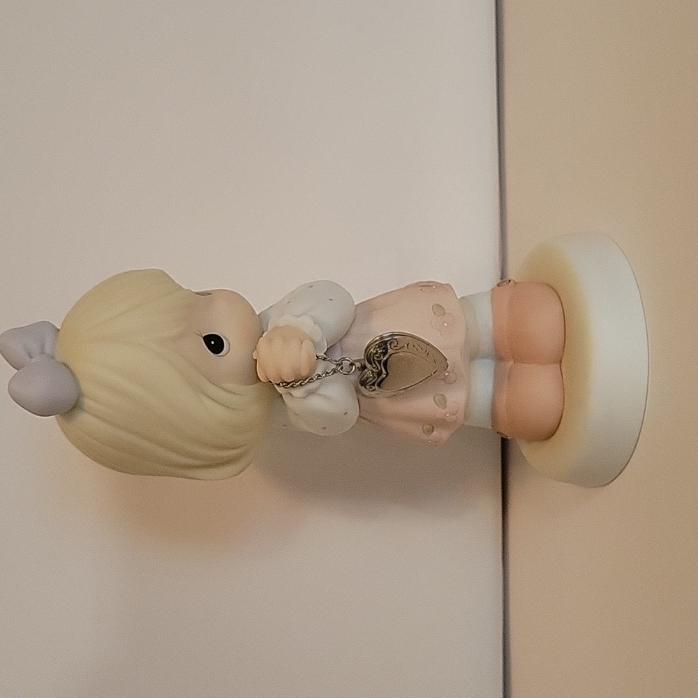 "Friends Are Held Within The Heart" figurine by Precious Moments.